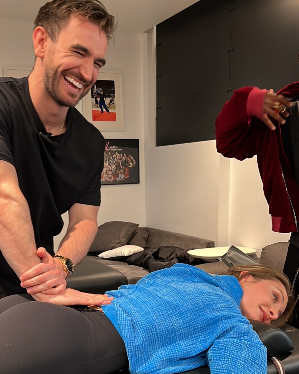 DFD Dance Specialist Adam Quigley laughing with a dancer during treatment at the Debbie Allen Dance Academy in Los Angeles